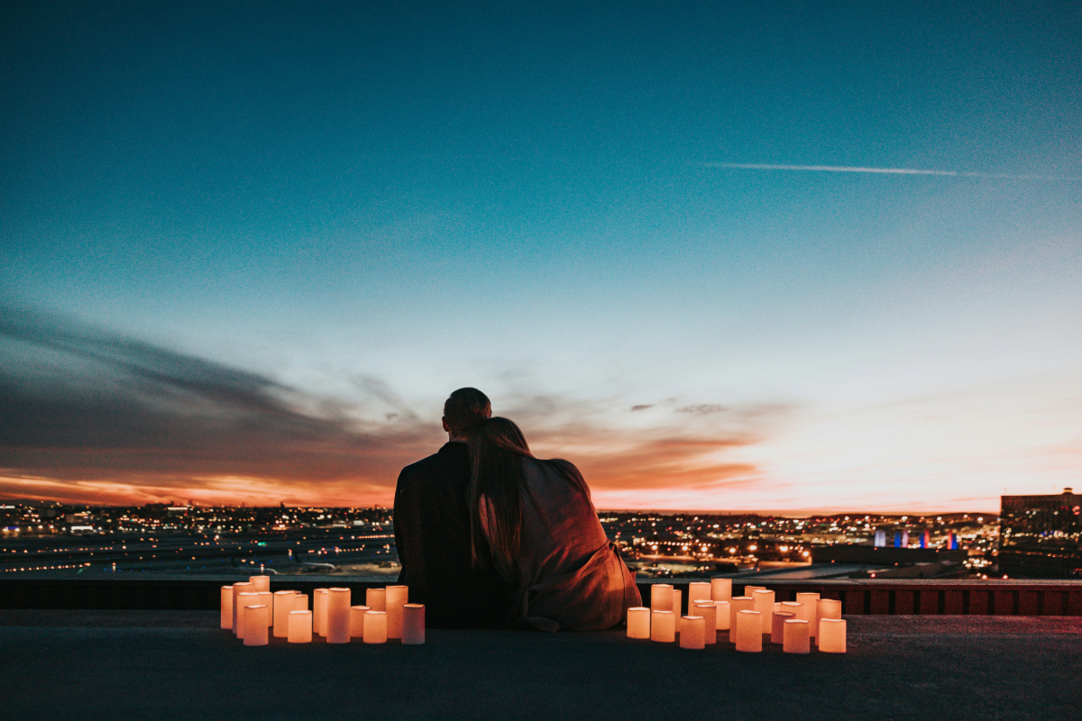 Married couple sitting close together at sunset, representing rehab for married couples recovering together